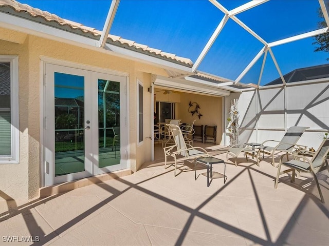 view of patio / terrace featuring french doors and glass enclosure