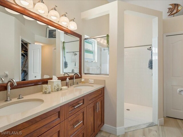 bathroom featuring vanity and tiled shower