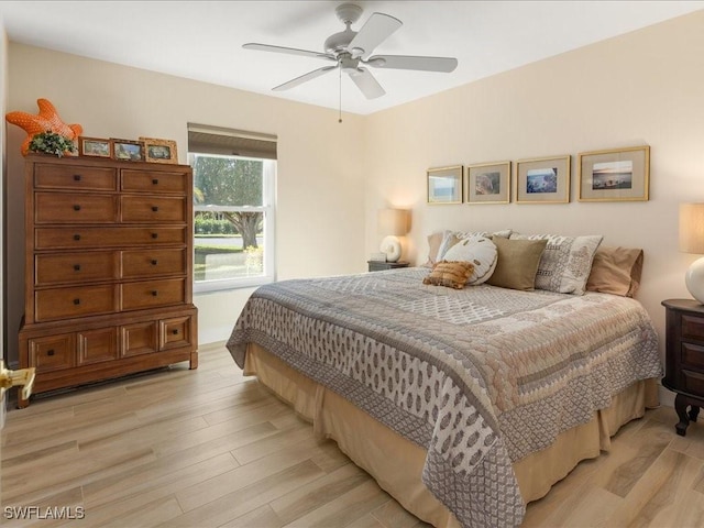 bedroom with ceiling fan and light hardwood / wood-style floors