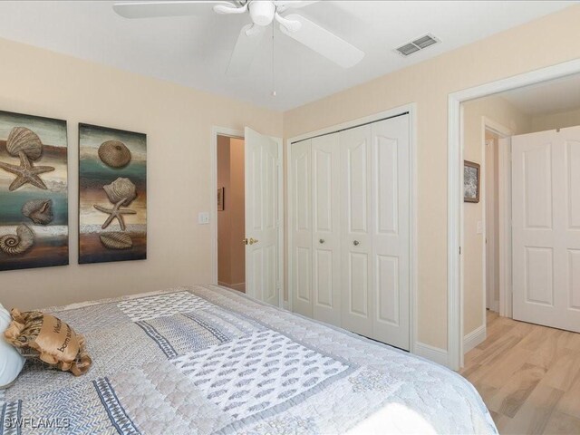 bedroom with ceiling fan, light wood-type flooring, and a closet