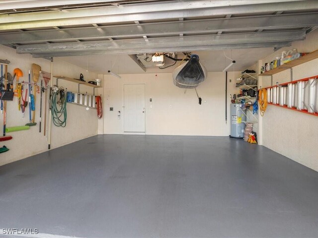 garage with electric water heater and a garage door opener