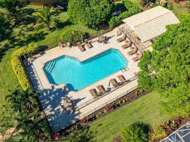 community pool featuring a patio and fence