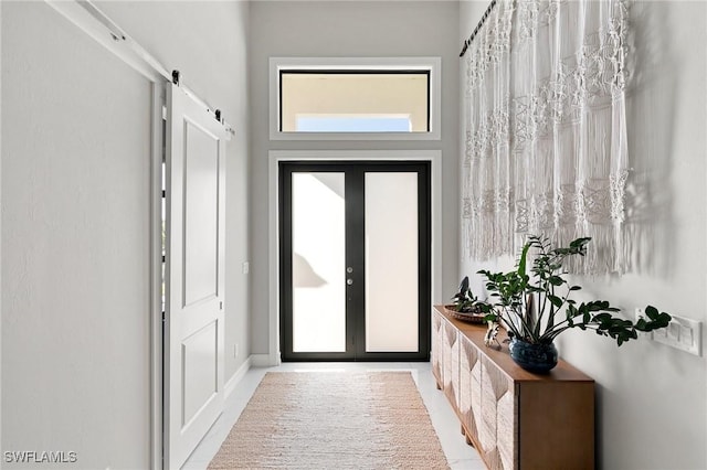 entryway with a barn door and french doors