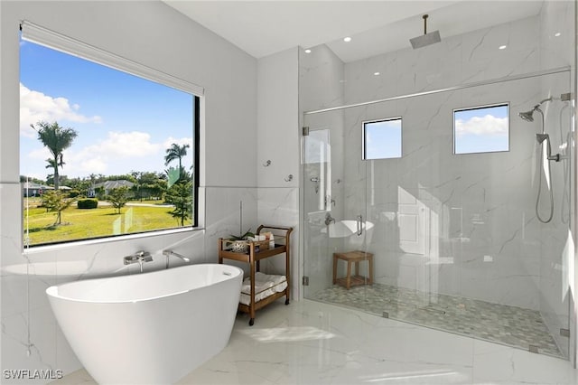 bathroom with plenty of natural light and independent shower and bath