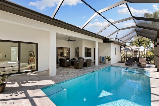 view of swimming pool featuring outdoor lounge area, a lanai, ceiling fan, and a patio area