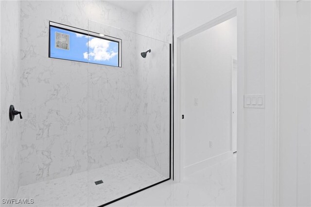 bathroom with tiled shower