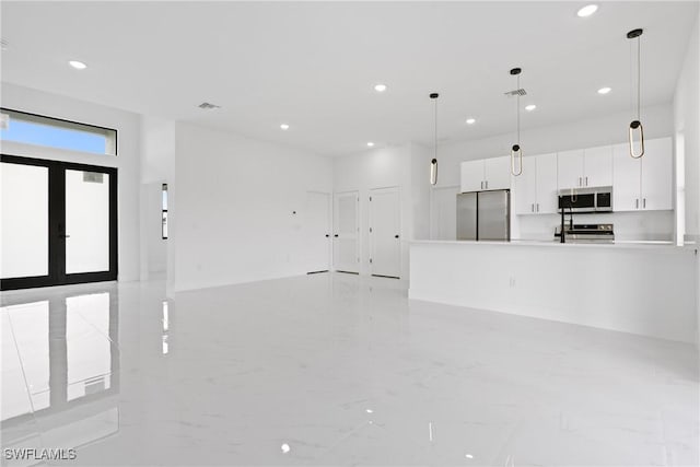 unfurnished living room featuring french doors