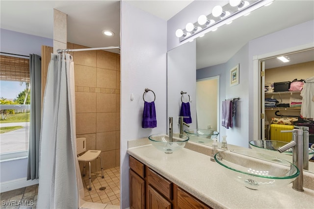 bathroom with tile patterned flooring, vanity, and a shower with shower curtain