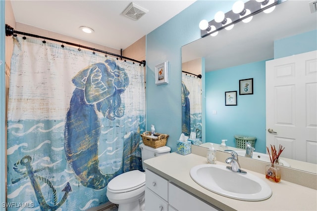 bathroom featuring vanity, curtained shower, and toilet