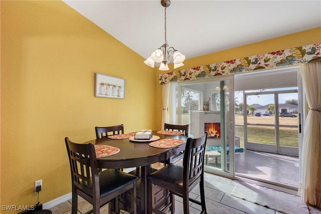 tiled dining space with vaulted ceiling and a notable chandelier