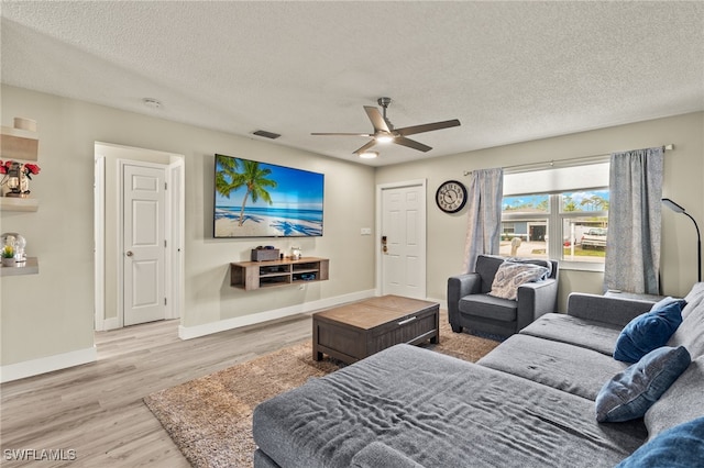 bedroom with ceiling fan, a textured ceiling, and wood-type flooring