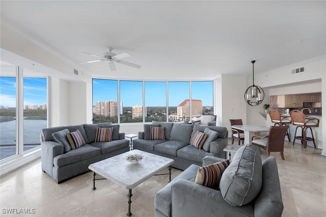 60 Seagate Dr Unit 1606, Naples, FL 34103 - living room featuring plenty of natural light, crown molding, a chandelier, a ceiling fan, and a city view