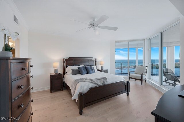 bedroom featuring a water view, access to outside, ceiling fan, and light hardwood / wood-style floors