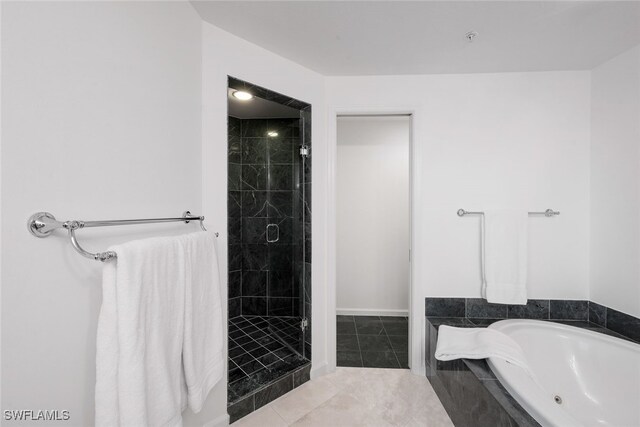 bathroom with tile patterned floors and independent shower and bath