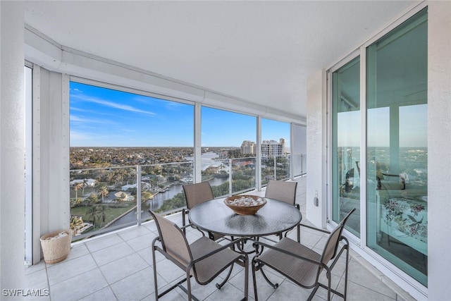 unfurnished sunroom featuring a wealth of natural light and a view of city