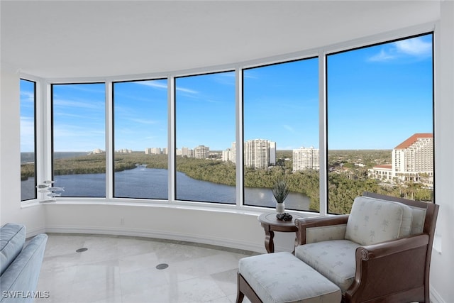 unfurnished sunroom with a water view