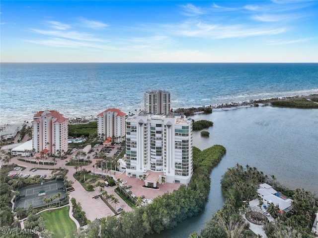 birds eye view of property featuring a beach view and a water view