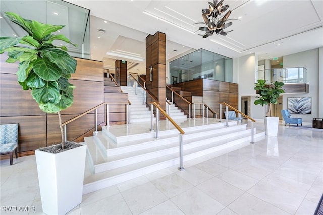 staircase featuring a tray ceiling and recessed lighting