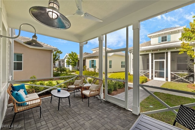 sunroom / solarium with ceiling fan