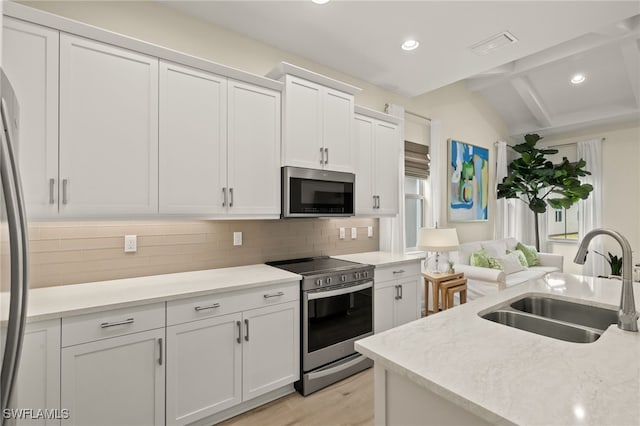 kitchen featuring white cabinets, appliances with stainless steel finishes, and sink