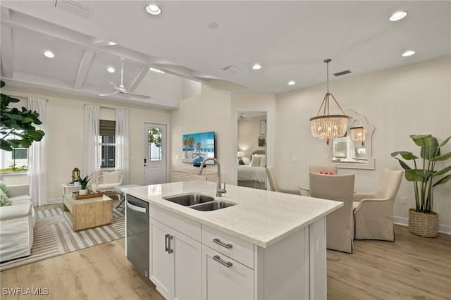 kitchen with white cabinetry, a center island with sink, dishwasher, hanging light fixtures, and sink