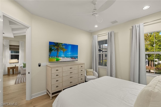 bedroom with ceiling fan and light hardwood / wood-style flooring