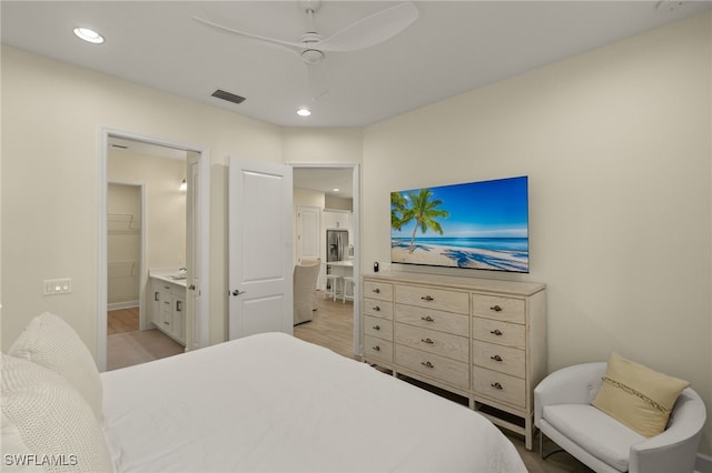 bedroom with ceiling fan, light hardwood / wood-style flooring, and ensuite bath