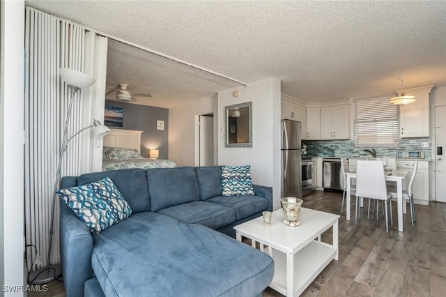 5600 Bonita Beach Rd Unit 508, Bonita Springs, FL 34134 - living area featuring a textured ceiling, ceiling fan, and wood finished floors