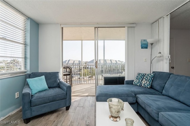 5600 Bonita Beach Rd Unit 508, Bonita Springs, FL 34134 - living room with a textured ceiling, floor to ceiling windows, and wood finished floors