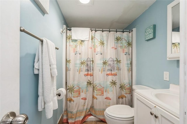 bathroom featuring walk in shower, vanity, and toilet