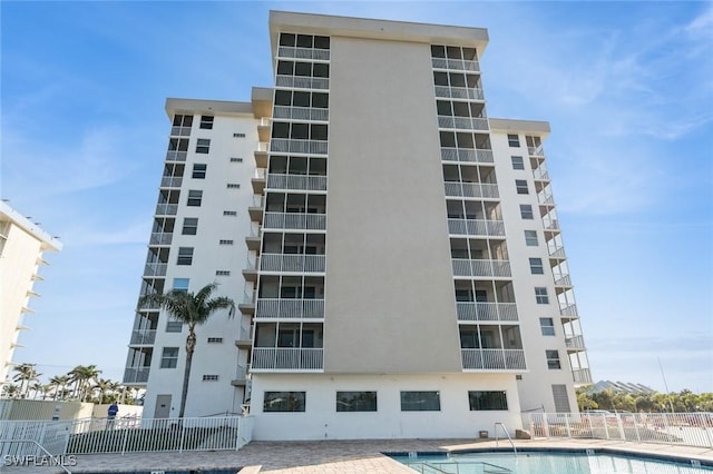 view of building exterior featuring a community pool