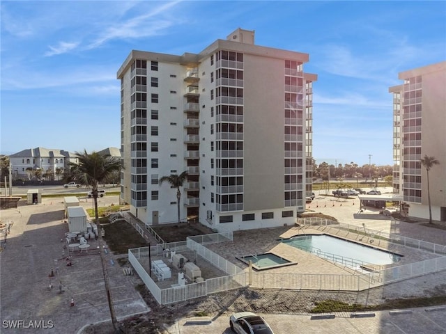 5600 Bonita Beach Rd Unit 508, Bonita Springs, FL 34134 - view of building exterior with fence and a community pool
