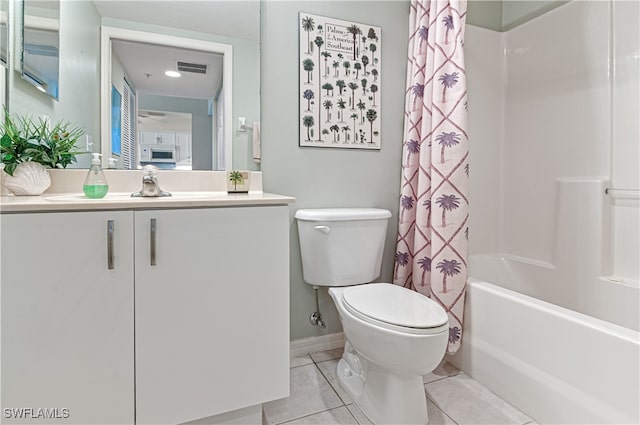 full bathroom with tile patterned flooring, shower / bath combination with curtain, toilet, and vanity