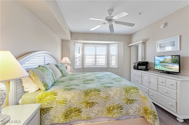 bedroom with ceiling fan and dark wood-type flooring