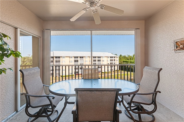 sunroom featuring ceiling fan and a wealth of natural light