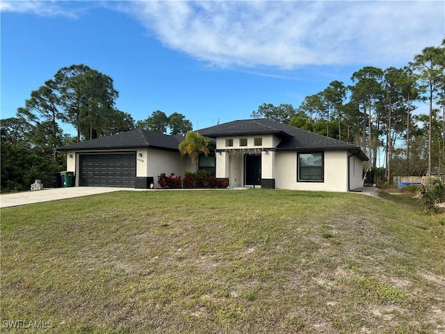 view of front of property featuring a garage and a front yard