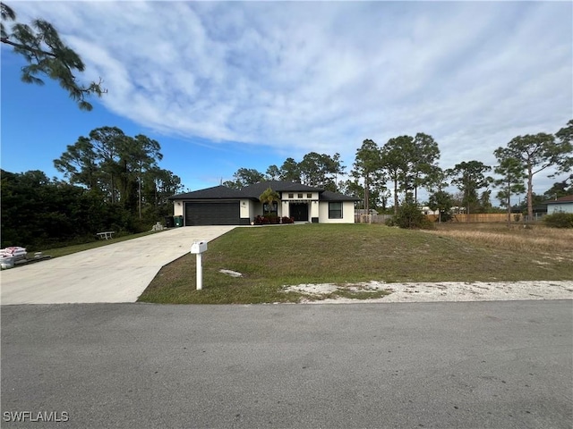 view of front of home with a garage and a front lawn