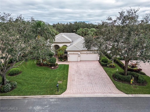 view of front facade with a front lawn and a garage