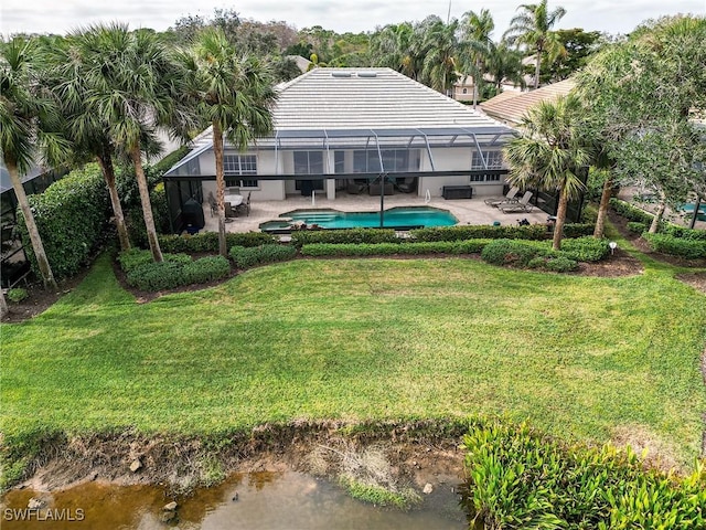 view of yard featuring a lanai, a water view, and a patio area