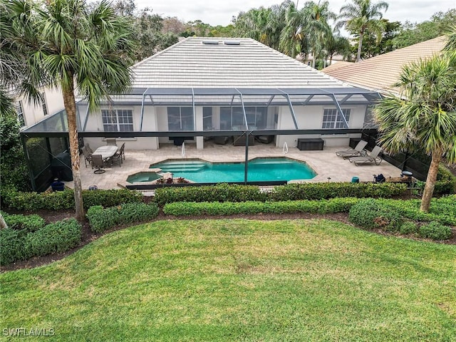 view of pool with glass enclosure, a patio area, and a lawn