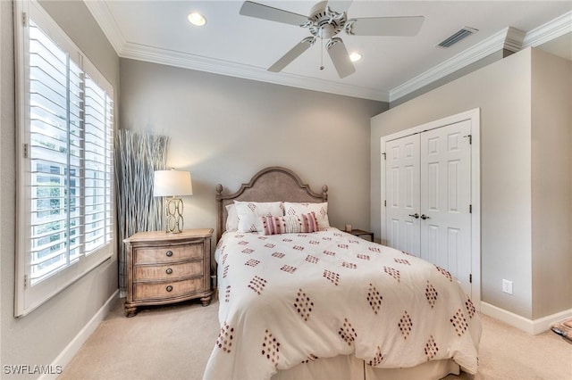 carpeted bedroom featuring ceiling fan, crown molding, a closet, and multiple windows