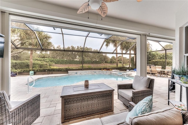 view of swimming pool featuring ceiling fan, a patio, glass enclosure, and outdoor lounge area