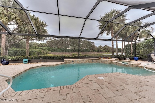 view of swimming pool featuring a lanai, a patio area, and an in ground hot tub