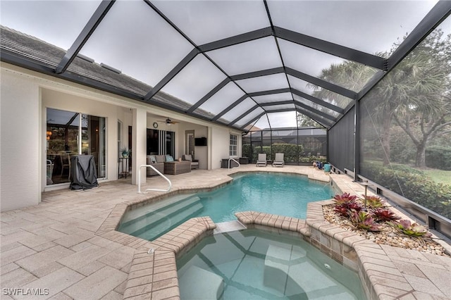 view of pool featuring a lanai, a patio area, ceiling fan, and an in ground hot tub