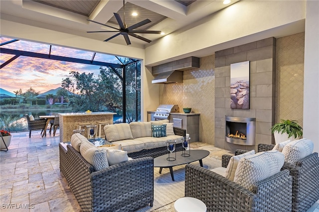 living room featuring ceiling fan, a tile fireplace, beamed ceiling, and coffered ceiling