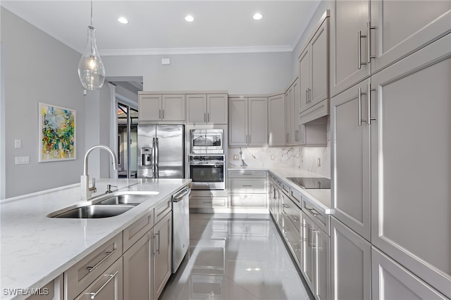 kitchen with gray cabinets, stainless steel appliances, hanging light fixtures, crown molding, and sink