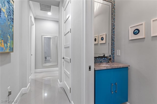 hallway featuring light tile patterned floors and sink