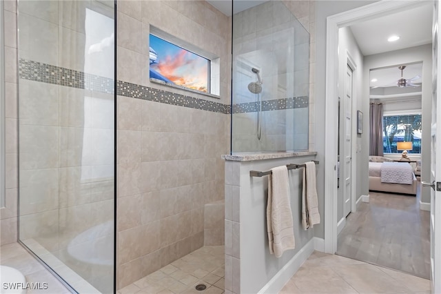 bathroom with tile patterned floors and a tile shower