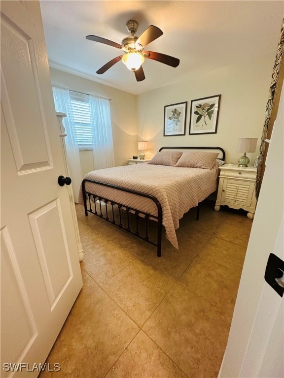 bedroom featuring ceiling fan and light tile patterned flooring