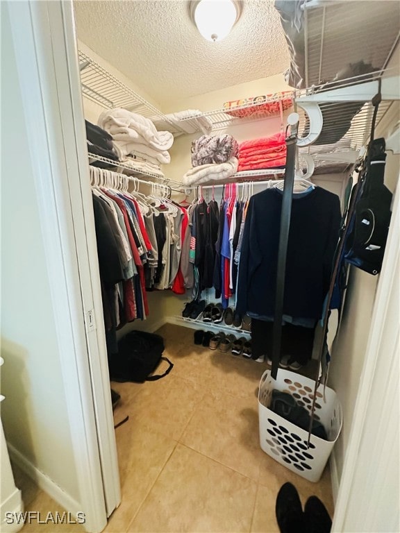 spacious closet with tile patterned floors